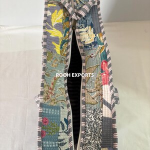 May include: A quilted tote bag with a patchwork design featuring floral and botanical patterns in shades of blue, gray, yellow, and pink. The bag has a gray zipper and striped handles. The text "ROOH EXPORTS" is visible.