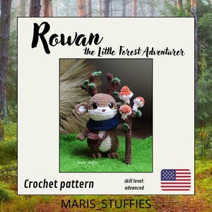 May include: A crochet pattern titled Rowan the Little Forest Adventurer by MARIS_STUFFIES. The image shows a brown and white crocheted creature with antlers, a dark blue scarf, and a brown staff topped with three orange and white mushrooms.