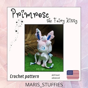 Op de afbeelding: Een haakpatroon getiteld Primrose the Fairy Kitty door MARIS_STUFFIES. De afbeelding toont een wit, roze en blauw gehaakt wezen met grote oren en lange lintachtige aanhangsels. De tekst geeft een gevorderd vaardigheidsniveau aan.
