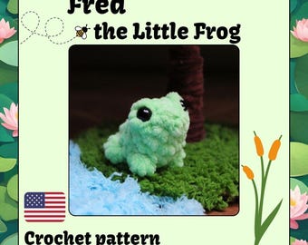 May include: Crochet pattern for a green frog amigurumi toy named Fred the Little Frog. The pattern includes a US flag and the text "Crochet pattern".