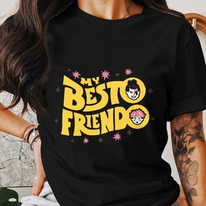 May include: Black t-shirt with a yellow graphic that says "My Best Friendo" with two cartoon faces. The faces are of a person with black hair and a person with pink hair.