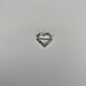 May include: Silver heart-shaped buckle with clear rhinestones.