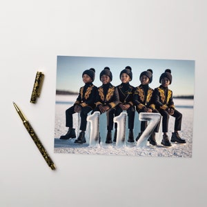 May include: Five young boys wearing black and gold jackets and matching black beanies pose on a snowy background. They are standing on ice blocks that spell out "1117".