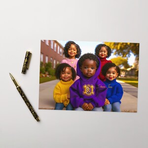 May include: Five children, four girls and one boy, are wearing colorful sweaters and posing for a photo. The boy is wearing a purple hoodie with a gold emblem that says "1911" and "Delta Sigma Theta".
