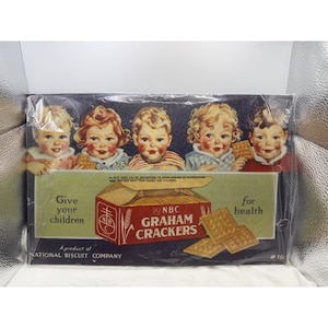 May include: A vintage National Biscuit Company advertisement for NBC Graham Crackers featuring five illustrated children and a red box of crackers. The text reads: Give your children for health, NBC GRAHAM CRACKERS, and A product of NATIONAL BISCUIT COMPANY.