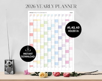 May include: A 2026 yearly planner with a colorful grid layout, featuring the text "DREAM UNTIL IT'S YOUR REALITY." The planner is available in A1, A2, and A3 sizes, measuring 40x30 inches. Includes an "INSTANT DOWNLOAD" graphic.