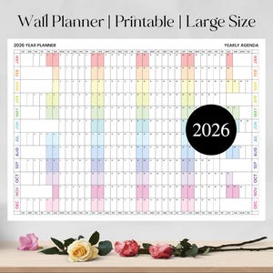 May include: A large, printable 2026 wall planner with a rainbow color scheme. The calendar features a yearly agenda layout with months and days clearly marked. The text "Wall Planner | Printable | Large Size" is at the top.
