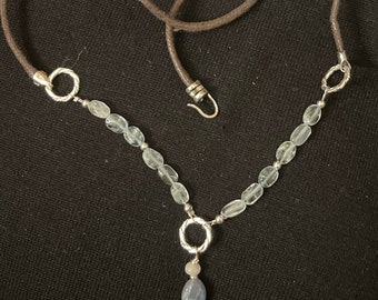 Unique aquamarine and kyanite gemstones strung with brown cording and sterling silver hook clasp and embellishments