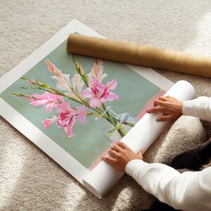 May include: A painting of pink gladioli flowers in a clear glass vase on a green background.