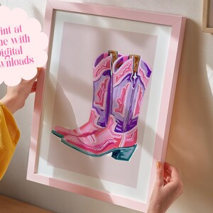 May include: A digital illustration of a pair of pink and purple cowboy boots with intricate designs. The boots are set against a light pink background.