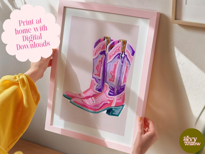 May include: A digital illustration of a pair of pink and purple cowboy boots with intricate designs. The boots are set against a light pink background.