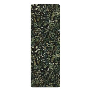 May include: A black yoga mat with a green and white floral pattern. The pattern features various types of leaves and flowers.