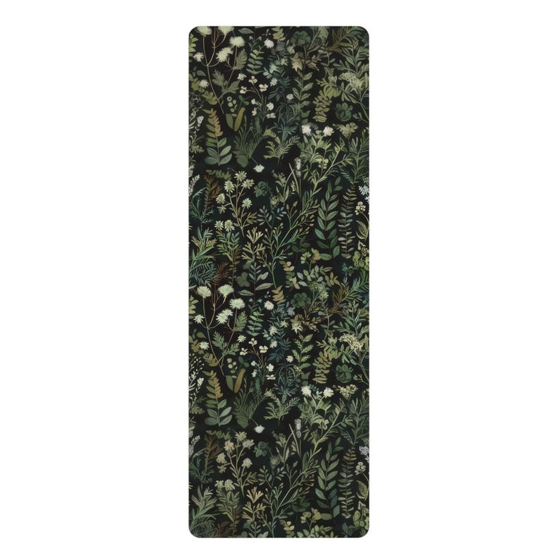 May include: A black yoga mat with a green and white floral pattern. The pattern features various types of leaves and flowers.