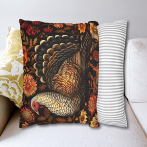 May include: A decorative throw pillow with a black background featuring a detailed illustration of a turkey surrounded by colorful flowers. The pillow is perfect for adding a touch of autumnal charm to your home decor.