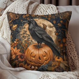 May include: Square decorative pillow featuring a black raven perched on a carved orange pumpkin. The background includes a full moon, autumn leaves, and a dark blue sky. Halloween-themed home decor.