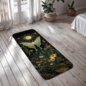 May include: A black and green yoga mat with a moon, a green luna moth, and floral designs.