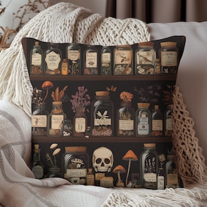 May include: Decorative throw pillow featuring a dark background with a shelf design. The shelf displays various glass jars and bottles filled with herbs, mushrooms, and other curiosities. A skull and mushrooms are also present, creating a gothic or apothecary theme.