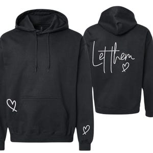 May include: Black hoodie with a front pocket and hood. The back of the hoodie has the words "Let them" in white script with a heart symbol. A white heart is on the front and sleeve.