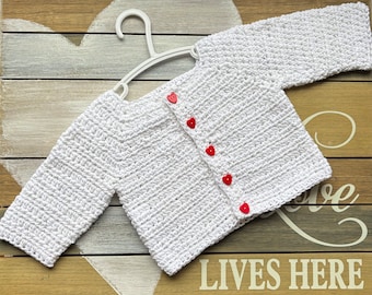 Crochet cotton baby sweater in white with red buttons