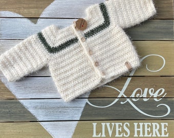 Crochet baby sweater in cream and forest green.  Super soft cashmere feel.