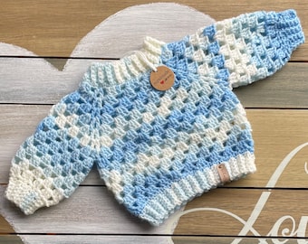 Crochet baby sweater in blue and white