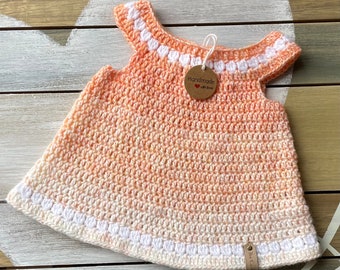 Crochet baby girl dress in peach and white.  Orange dress.