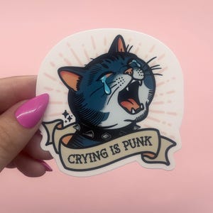 Traditional tattoo style crying cat vinyl sticker with spiked collar and “Crying is punk” banner