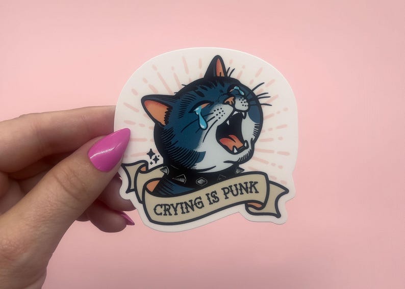 Traditional tattoo style crying cat vinyl sticker with spiked collar and “Crying is punk” banner