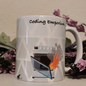 May include: White ceramic mug with a gray and white geometric pattern. The mug has a black handle and features a cartoon illustration of a computer on fire with the text "coding Emporium".
