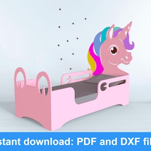 May include: A pink wooden toddler bed shaped like a unicorn. The headboard features a unicorn head with a colorful mane and horn. The bed frame has a low profile with rounded edges and a gray mattress. The text "Instant download: PDF and DXF files" is at the bottom.