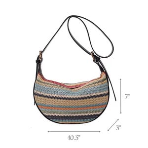 May include: A crescent-shaped shoulder bag with a woven, striped pattern in shades of blue, tan, and pink. The bag has a black leather strap and trim. The bag is 10.5 inches wide, 7 inches high, and 3 inches deep.