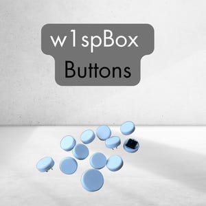 Może przedstawiać: Grupa jasnoniebieskich, okrągłych guzików rozrzuconych na białym tle. Nad guzikami widnieje napis "w 1spBox Buttons".