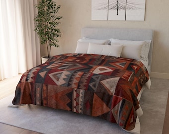 May include: A bed with a patterned blanket. The blanket features a geometric design in shades of red, brown, gray, and cream. The bed has white pillows and a gray headboard. A tree is in the background.