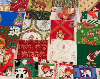 May include: A collection of Christmas-themed fabric squares with various festive patterns. Designs include angels, snowmen, Christmas trees, and holiday greetings. The fabrics feature red, green, blue, and white colors, creating a cheerful holiday aesthetic.