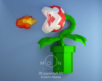 May include: A 3D papercraft DIY model of a green Piranha Plant from the Super Mario Bros. video game series. The plant is in a green pipe and has a red and white mouth with sharp teeth. The plant is shooting a fireball.