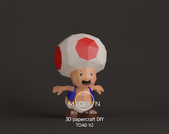 May include: A 3D papercraft DIY model of Toad from the Super Mario franchise. The model is made of white, red, blue, and yellow paper and is in a standing pose. The model is labeled "3D papercraft DIY TOAD V2" and "MOON STUDIO".