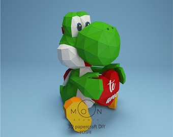 Op de afbeelding: Een groene origami Yoshi die een rood hart vasthoudt met de woorden "te amo" erop. De Yoshi zit op een blauwe achtergrond met de woorden "3D papercraft DIY YOSHI" eronder.