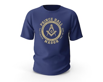May include: A navy blue t-shirt with a gold circle design featuring a compass and the text "Prince Hall Mason" with the dates "March 6, 1775" and "Sept. 29, 1784".