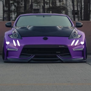 May include: A purple sports car with white accents on the front bumper. The car has a black hood and a black front bumper.