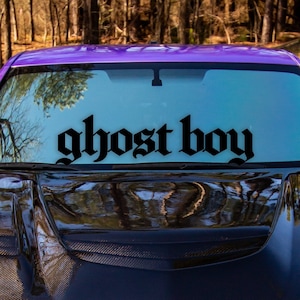 May include: A purple car with a black carbon fiber hood and a black "ghost boy" decal on the windshield.
