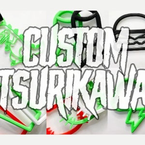 May include: Green, white, and black 3D printed custom cookie cutters with the text "CUSTOM TSURIKAWA". The cutters are shaped like a dinosaur, a burger, a lightning bolt, and a few other abstract shapes.