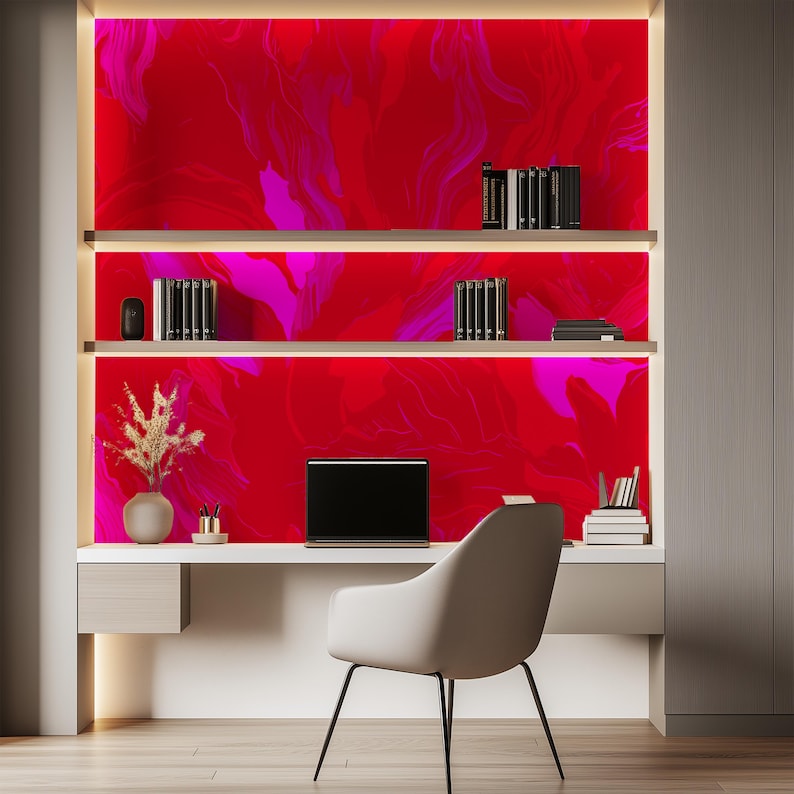 May include: A home office workspace with a white desk and chair. The wall behind the desk is a bright red and pink abstract design. A laptop computer is on the desk.