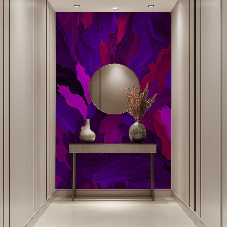 May include: A hallway with a purple and pink abstract art print on the wall. A round mirror hangs above a console table with a vase of dried flowers and a decorative vase.