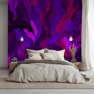 May include: A bedroom with a bed with white linens and two white pillows. The wall behind the bed is painted with a purple, pink, and black abstract design.