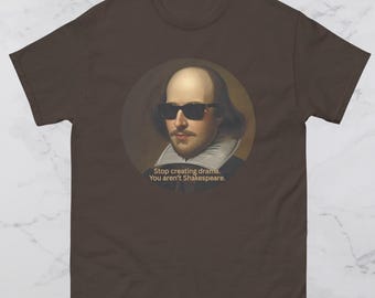 May include: A brown t-shirt featuring a portrait of William Shakespeare wearing sunglasses. The portrait is in a circular frame. Below the image is the text: "Stop creating drama. You aren't Shakespeare."