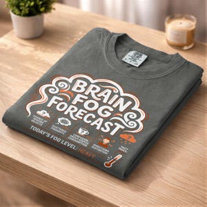 May include: A set of three ceramic mugs with a speckled, matte finish. The mugs are in cream, light grey, and dark grey. Each mug has a simple, minimalist design, ideal for coffee or tea.