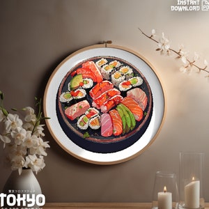 May include: A cross stitch pattern of a plate of sushi with various types of fish, avocado, and rice. The pattern is in a round hoop and is ready to be stitched.