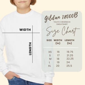 May include: A white youth crewneck sweatshirt with a size chart overlay. The chart displays the Gildan 18000B model with width and length measurements in inches for sizes XS through XL, ranging from 16 to 20 inches in width and 19.75 to 25.5 inches in length.