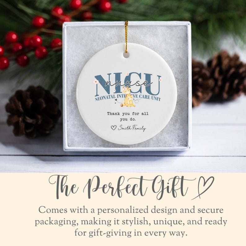 May include: A white ceramic bauble with a blue circle in the centre. The circle features the text "NICU nurse" with a small illustration of a baby giraffe. The text "NEONATAL INTENSIVE CARE UNIT" is below the illustration. The text "Thank you for all you do." is below the unit name. The text "Smith Family" is below the thank you message.