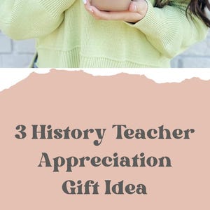 May include: A white tumbler with a black and white illustration of a ship and the text "HISTORY Teacher SPILLING THE TEA since 1773". The tumbler has a bamboo lid and a straw. The tumbler is sitting on a white surface.